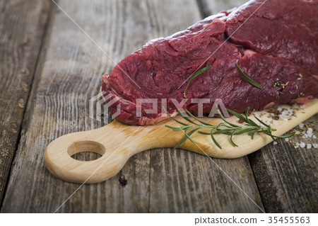 Beef Steak with fresh herbs on wooden board. Beef Steak with fresh herbs on wooden board. 35455563