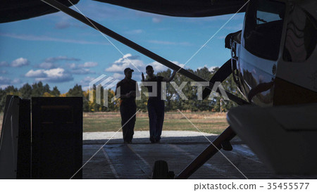 Men entering hangar 35455577