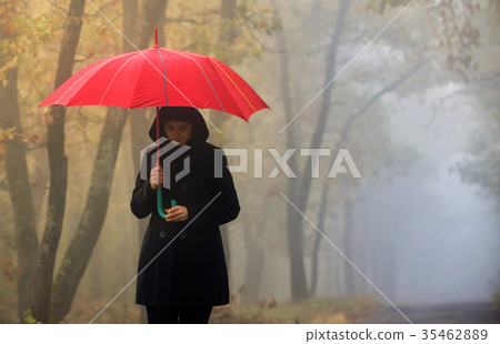 Depressed woman with red umbrella Depressed woman with red umbrella 35462889