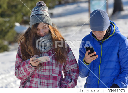 Kids with Smartphone in winter forest 35463073