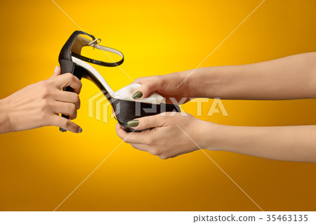 Brown woman shoe with female and male on hands Brown woman shoe with female and male on hands 35463135