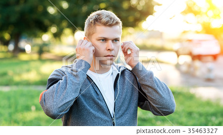 Athlete in the hands of headphones, concentration Athlete in the hands of headphones, concentration 35463327