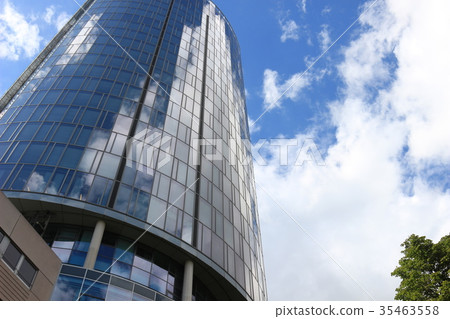 Clouds and blue sky reflected in a building 35463558