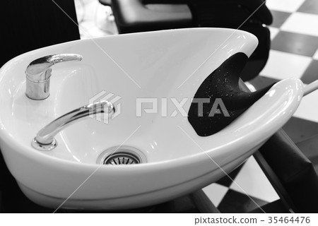 Hairdresser makes hairstyle a man with a beard Hairdresser makes hairstyle a man with a beard 35464476