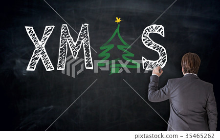 Businessman writes XMAS on blackboard concept Businessman writes XMAS on blackboard concept 35465262