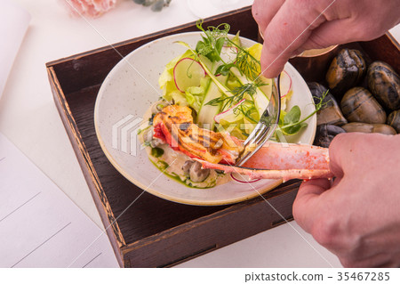 The cook a fork gets meat of the baked crab from a The cook a fork gets meat of the baked crab from a 35467285