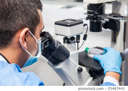 Male scientist looking at the microscope Male scientist looking at the microscope 35467441