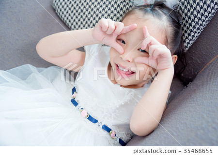 pretty girl lying on sofa and smiles pretty girl lying on sofa and smiles 35468655