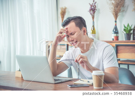 Young man sitting on chair and crying Young man sitting on chair and crying 35468938