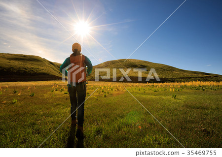 woman hiker with backpack hiking in sunrise woman hiker with backpack hiking in sunrise 35469755