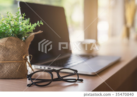 Laptop with cup of coffee in cafe Laptop with cup of coffee in cafe 35470840