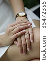 Woman hand with diamond ring and watch on her leg. 35472355