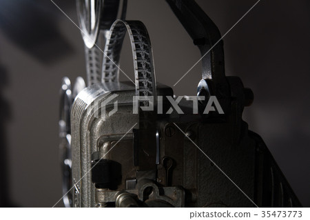 Close-up of 16 mm film on the projector Close-up of 16 mm film on the projector 35473773