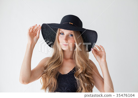 blonde girl with blue eyes a hat with a brim on a 35476104