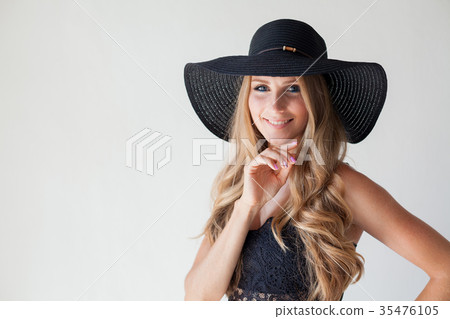 blonde girl with blue eyes a hat with a brim on a 35476105