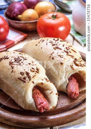 Sausage baked in dough. 35478756