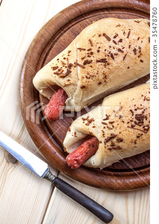 Sausage baked in dough. 35478760