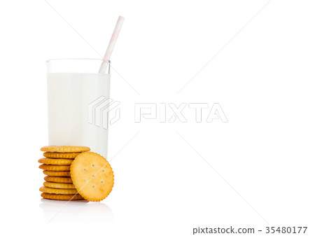 Glass of milk with round cheese crackers on white 35480177