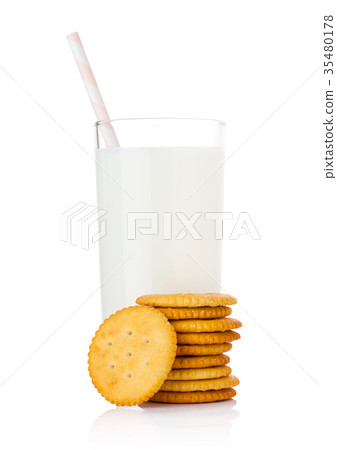 Glass of milk with round cheese crackers on white Glass of milk with round cheese crackers on white 35480178