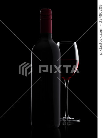 Glass of red wine with bottle with shape on black 35480209