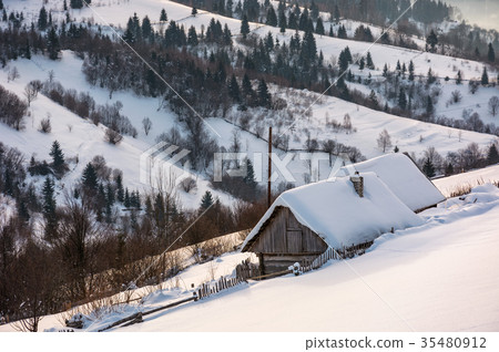 woodshed on hillside in deep snow woodshed on hillside in deep snow 35480912