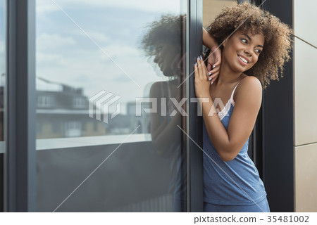 Outgoing mulatto girl standing near entrance Outgoing mulatto girl standing near entrance 35481002