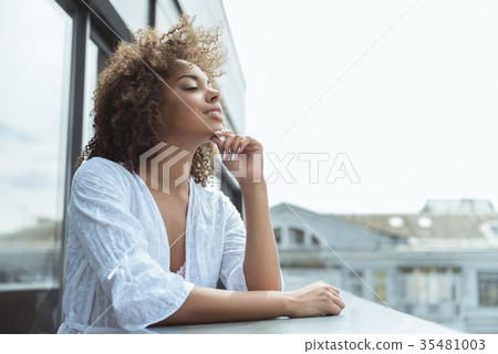 Beaming african woman watching at street Beaming african woman watching at street 35481003