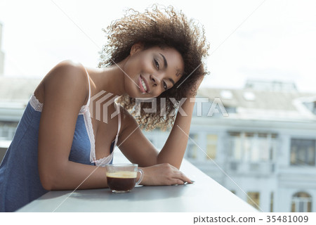 Outgoing young girl tasting beverage in morning 35481009