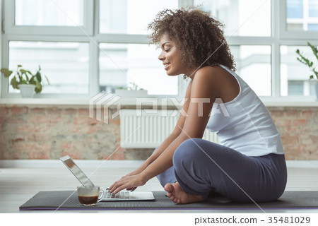 Outgoing girl working on laptop after training 35481029