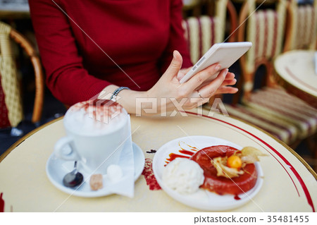 hands with mobile phone, cup of coffee and cakE hands with mobile phone, cup of coffee and cakE 35481455
