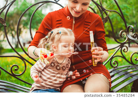 mother and daughter blow bubbles mother and daughter blow bubbles 35485284