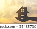 silhouette hand holding home 35485730