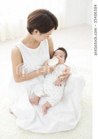 A woman who gently holds a baby A woman who gently holds a baby 35486384