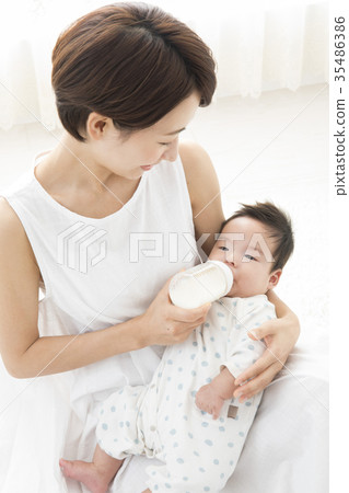 A woman who gently holds a baby A woman who gently holds a baby 35486386