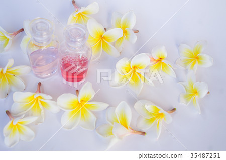 Dok champa flowers and small bottle of shampoo 35487251