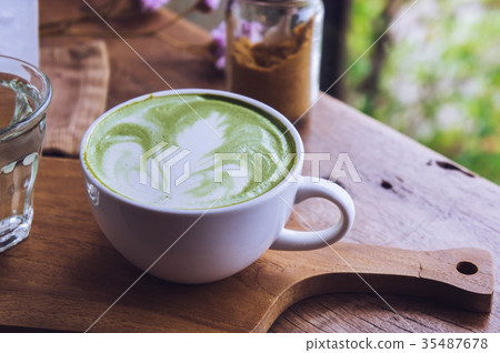 green tea hot drink latte white cup on wood table green tea hot drink latte white cup on wood table 35487678