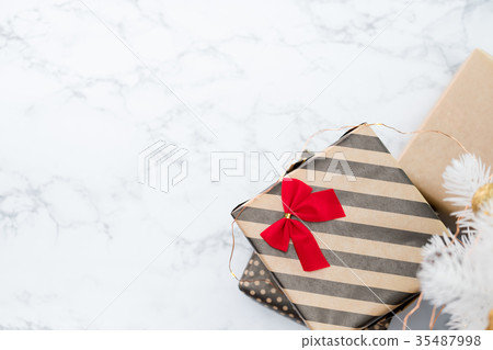 Top view of modern striped present with red bow Top view of modern striped present with red bow 35487998