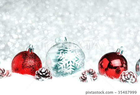 Christmas decoration ball on fur at silver bokeh Christmas decoration ball on fur at silver bokeh 35487999