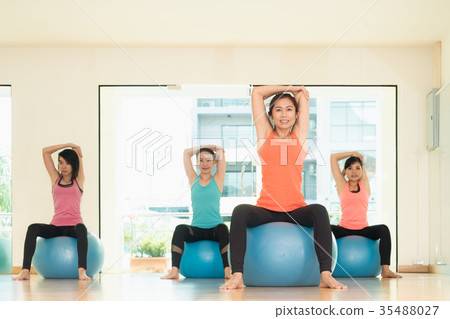 Yoga class in studio room,Group people doing yoga Yoga class in studio room,Group people doing yoga 35488027