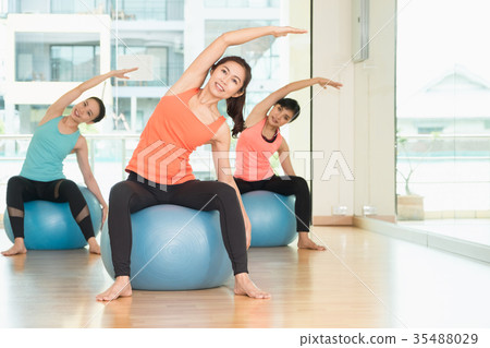 Yoga class in studio room,Group people doing yoga Yoga class in studio room,Group people doing yoga 35488029