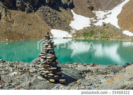 Stones pyramid at Blue lake in Aktru valley Altai Stones pyramid at Blue lake in Aktru valley Altai 35488322
