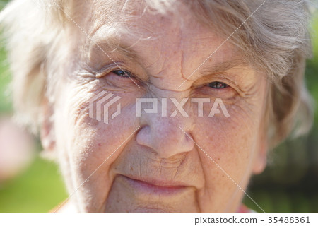 Portrait of smiling mature old woman outdoors 35488361