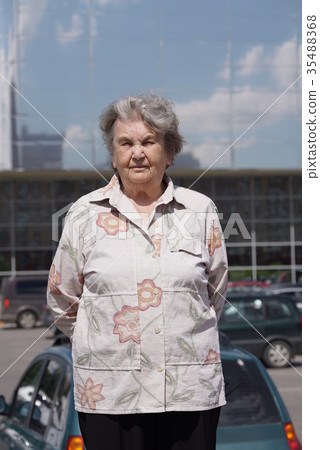 Portrait of serious old woman aged 80s outdoors Portrait of serious old woman aged 80s outdoors 35488368