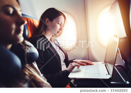 Female entrepreneur working on laptop sitting near 35488895