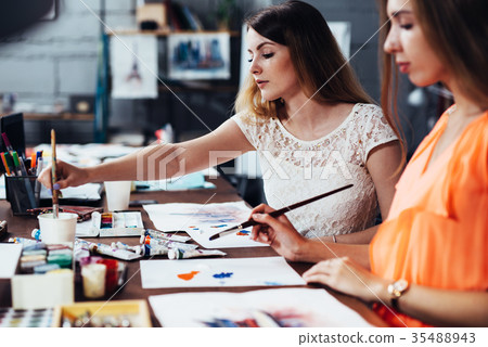 Two adult female students working on their 35488943