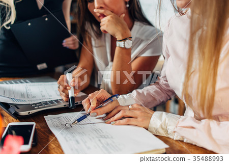 Close-up view of young women working on accounting 35488993