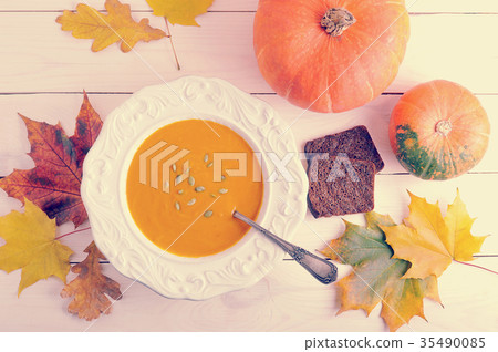 autumn still life of pumpkin soup, maple leaves autumn still life of pumpkin soup, maple leaves 35490085