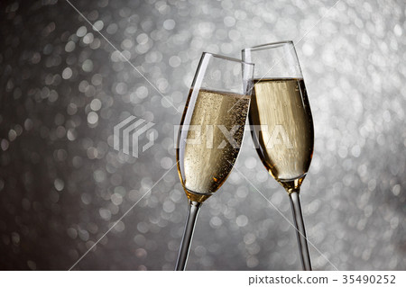 Picture of two wine glasses with champagne on gray Picture of two wine glasses with champagne on gray 35490252
