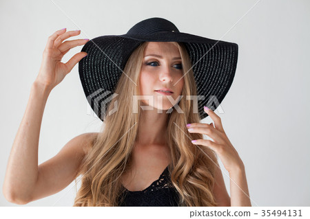 blonde girl with blue eyes a hat with a brim on a 35494131