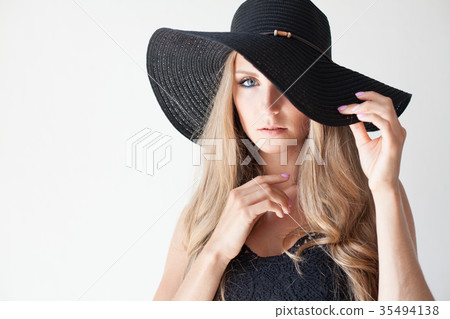 blonde girl with blue eyes a hat with a brim on a 35494138